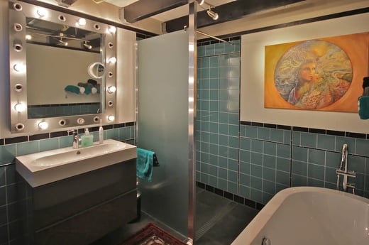 Luxurious bathroom with bathtub and walk-in rain shower.